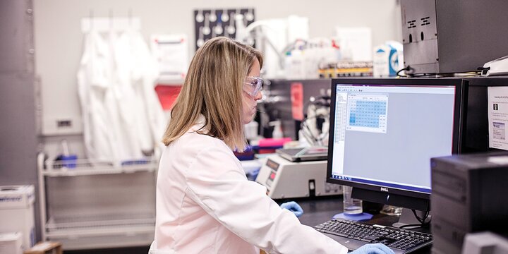 Graduate student working on a computer in a laboratory