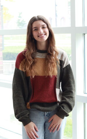 girl posed in multicolor sweater