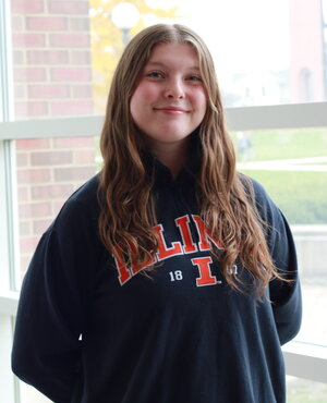 brunette posed in Illinois blue sweatshirt