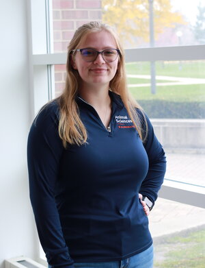 blonde girl with glasses in blue pullover shirt