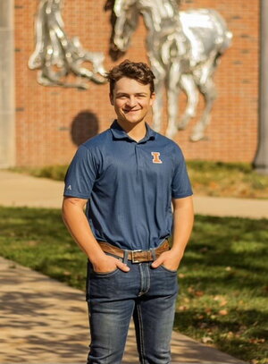 student posed outside animal science building