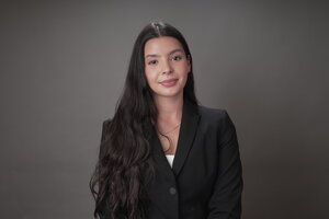 girl with long brunette hair, in black blazer