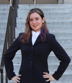brunette girl posed with black blazer