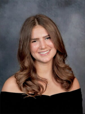 A person with brunette hair in an off the shoulder black dress.
