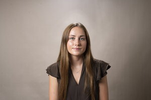 a person in brown shirt with blonde hair. 